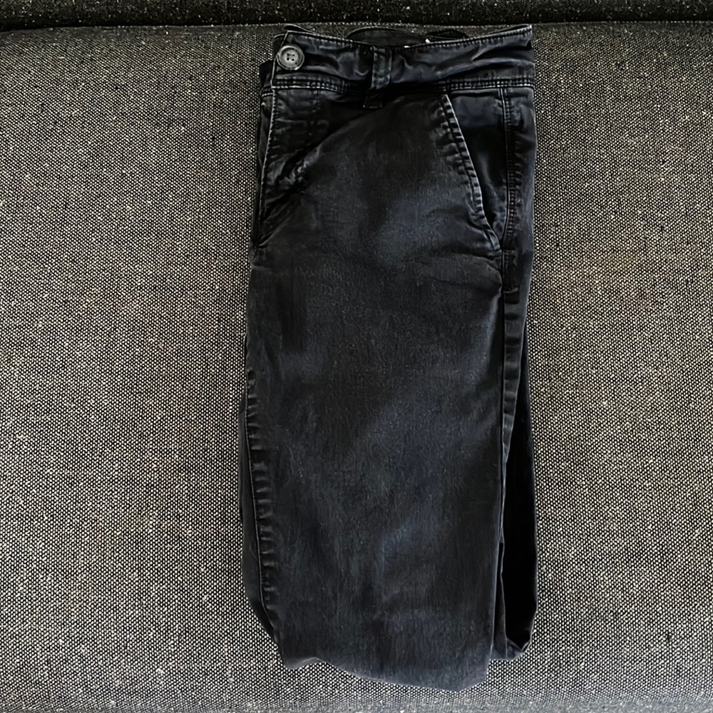 Black American Eagle jeans, worn.